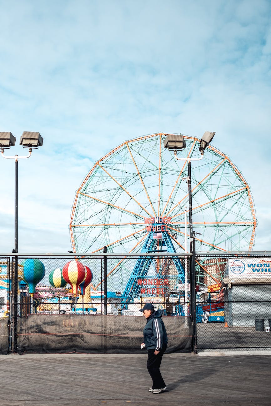 person passing by an amusement park