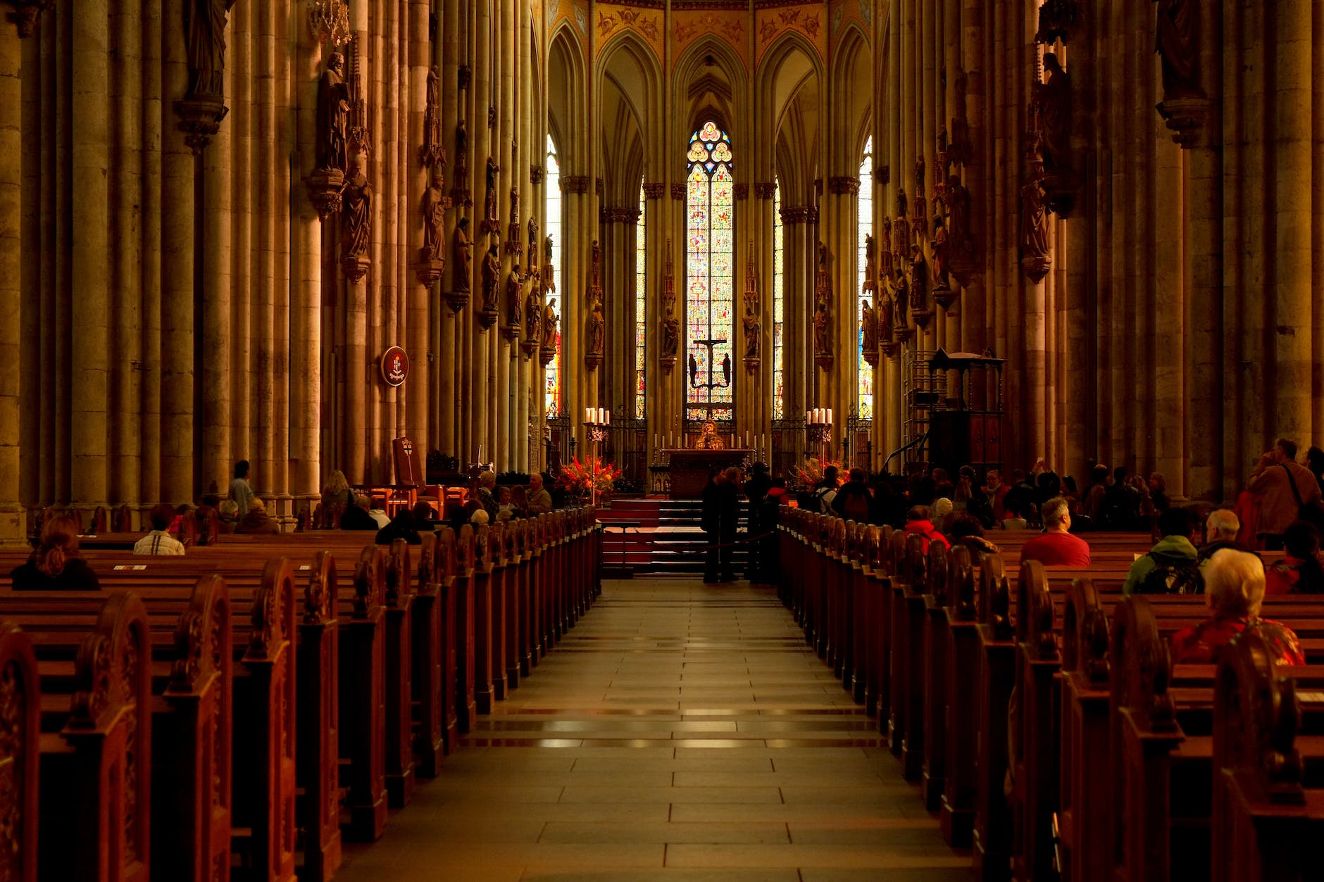 group of people sitting on cathedral bench