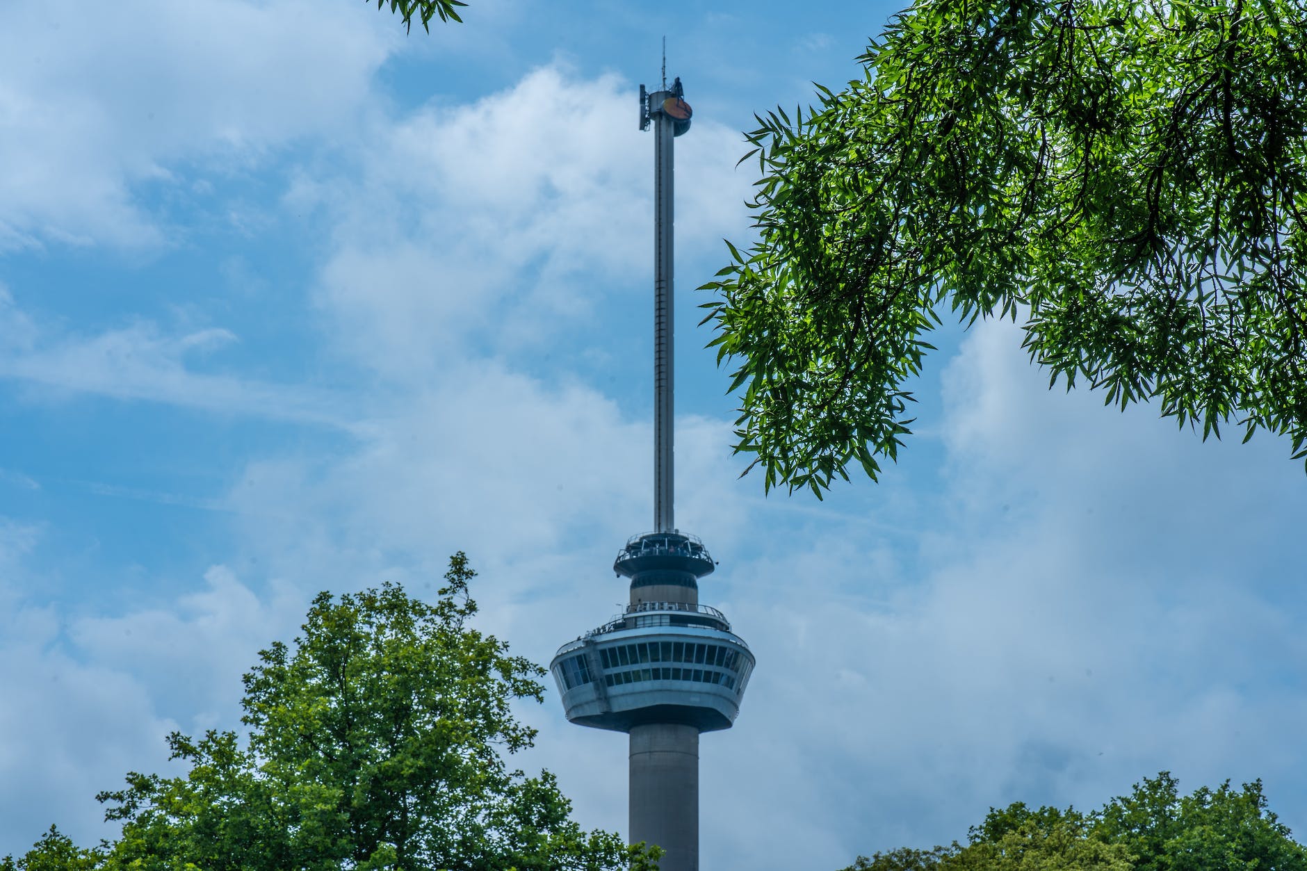 observation tower under white clouds and blue skies